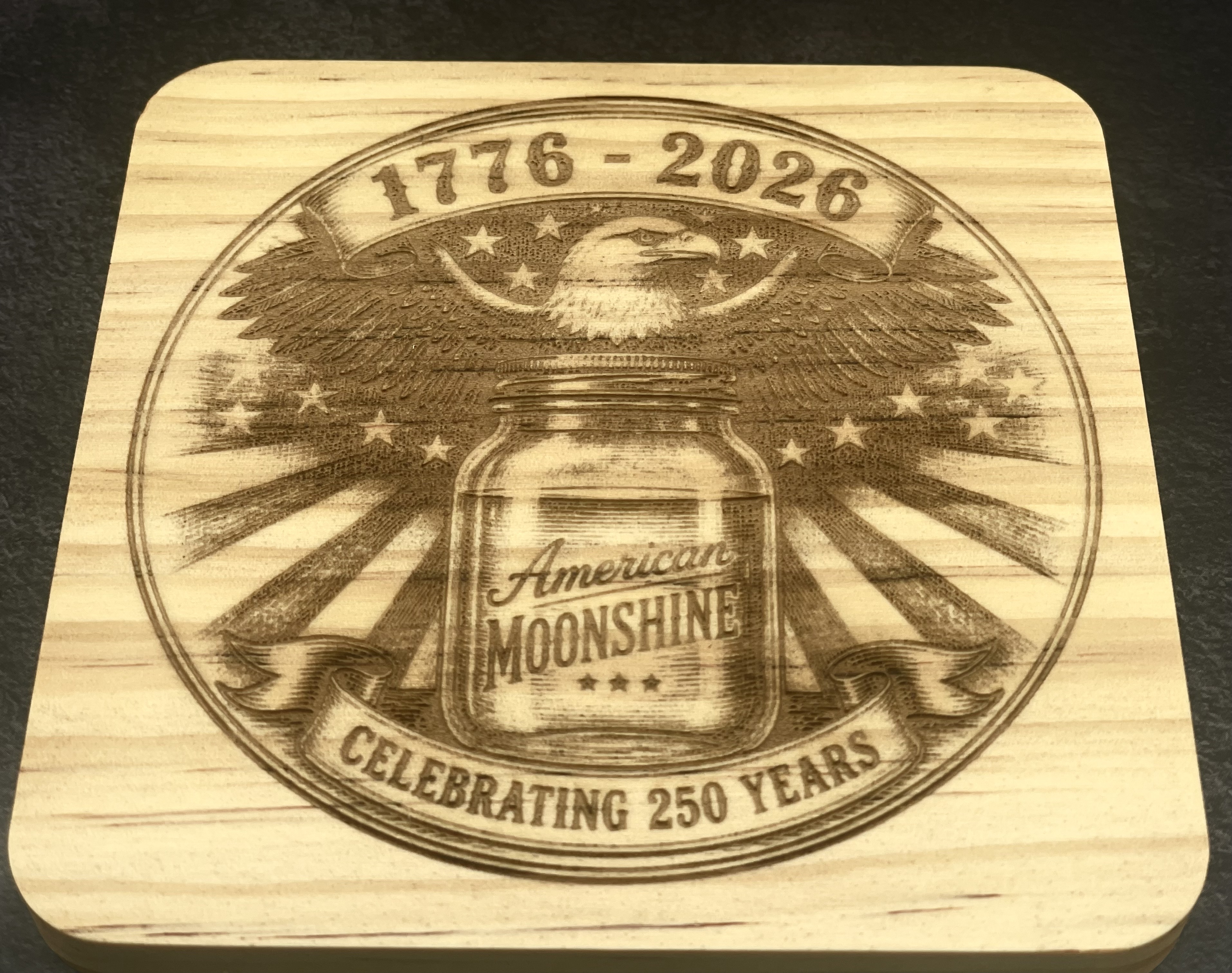 American Moonshine wood coaster with a 1776 to 2026 eagle design, laser engraved