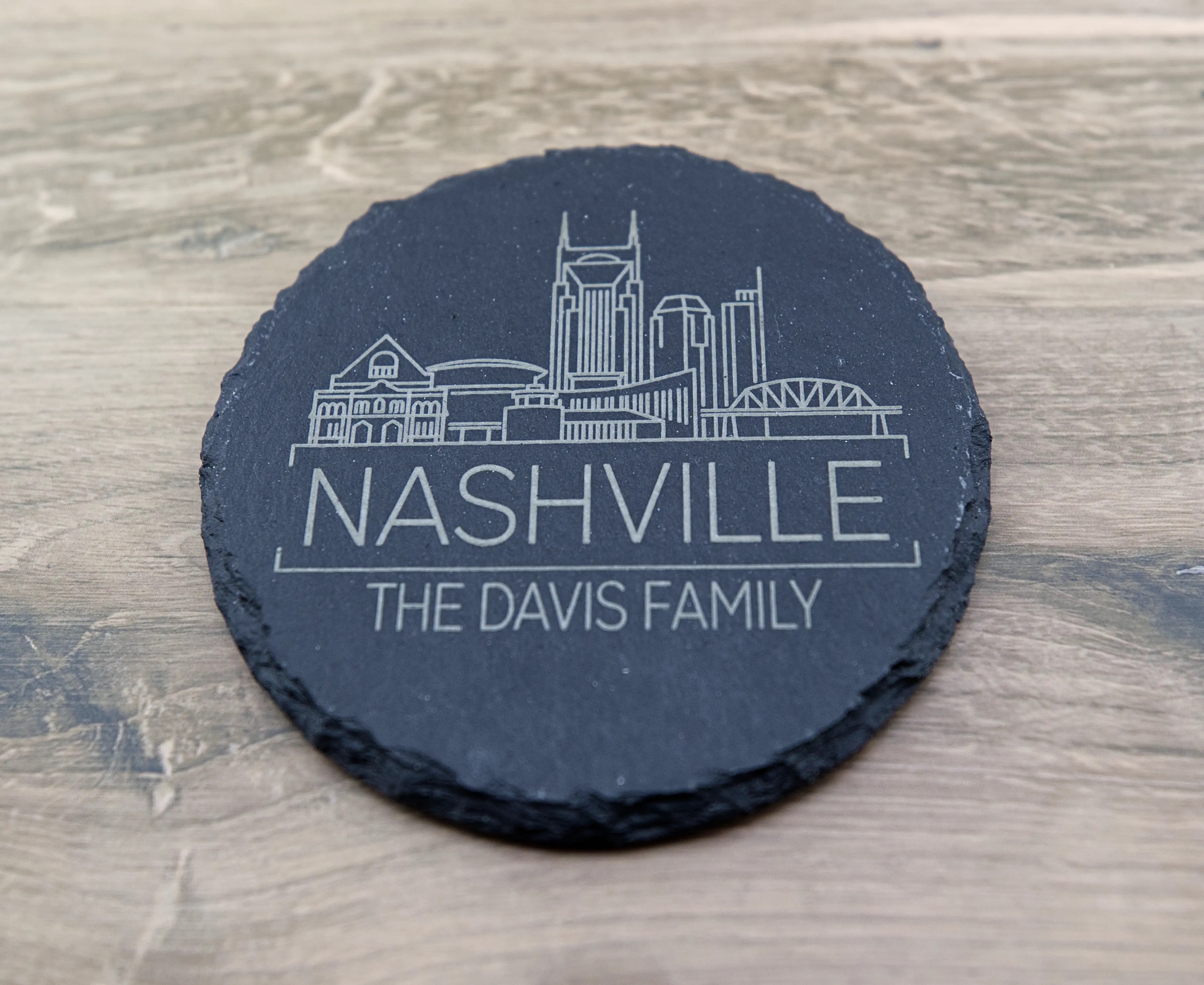 Personalized city skyline slate coaster engraved with a family name, made by BurnlineLab in Jurupa Valley, CA