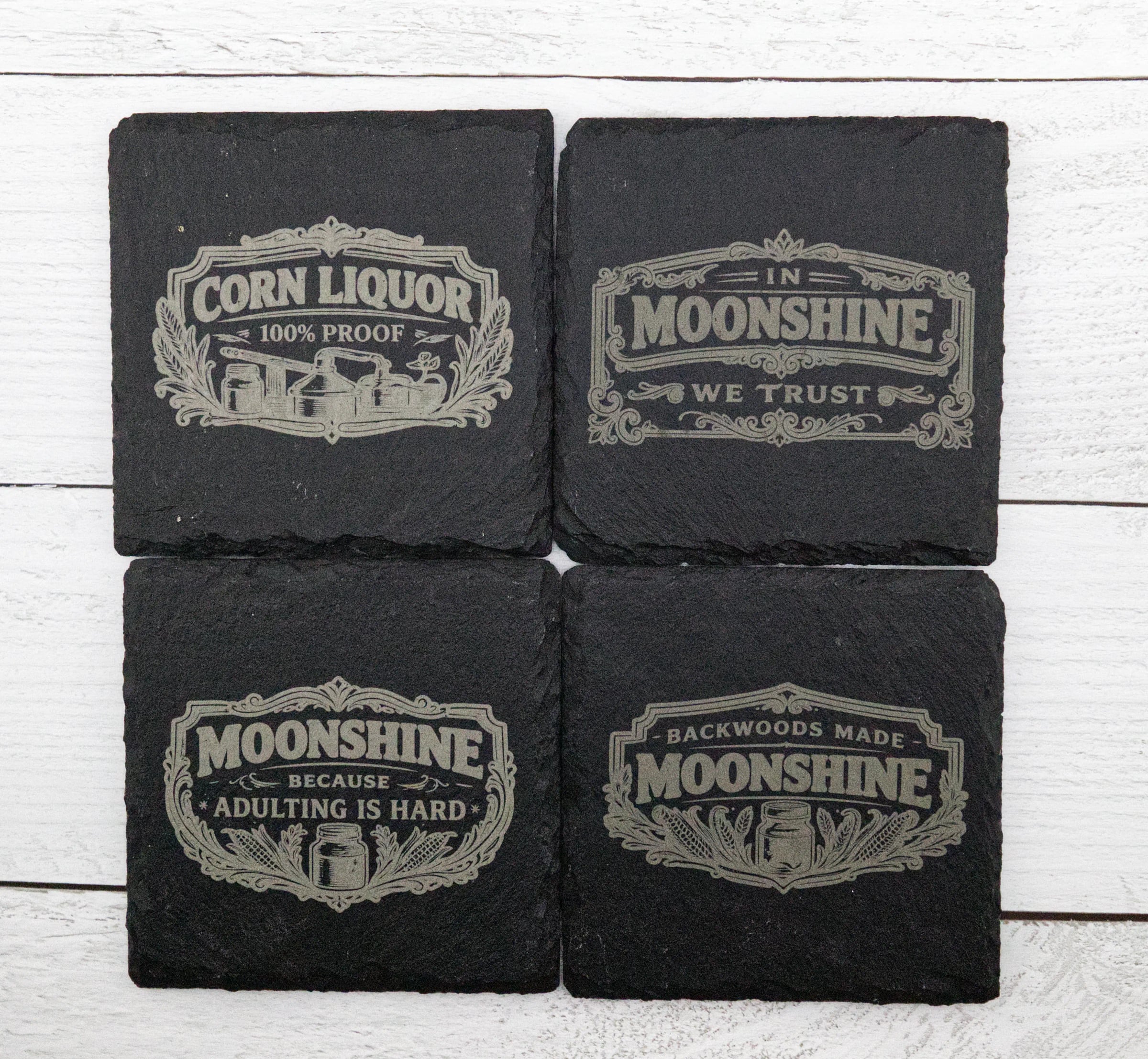 Set of laser-engraved moonshine slate coasters made by BurnlineLab in Jurupa Valley, CA
