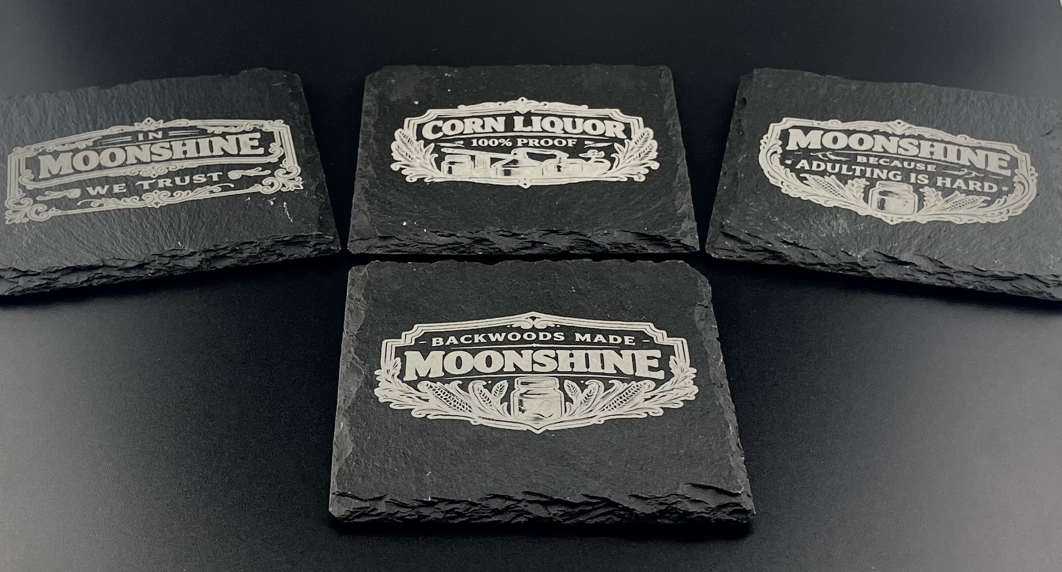 Set of laser-engraved moonshine slate coasters